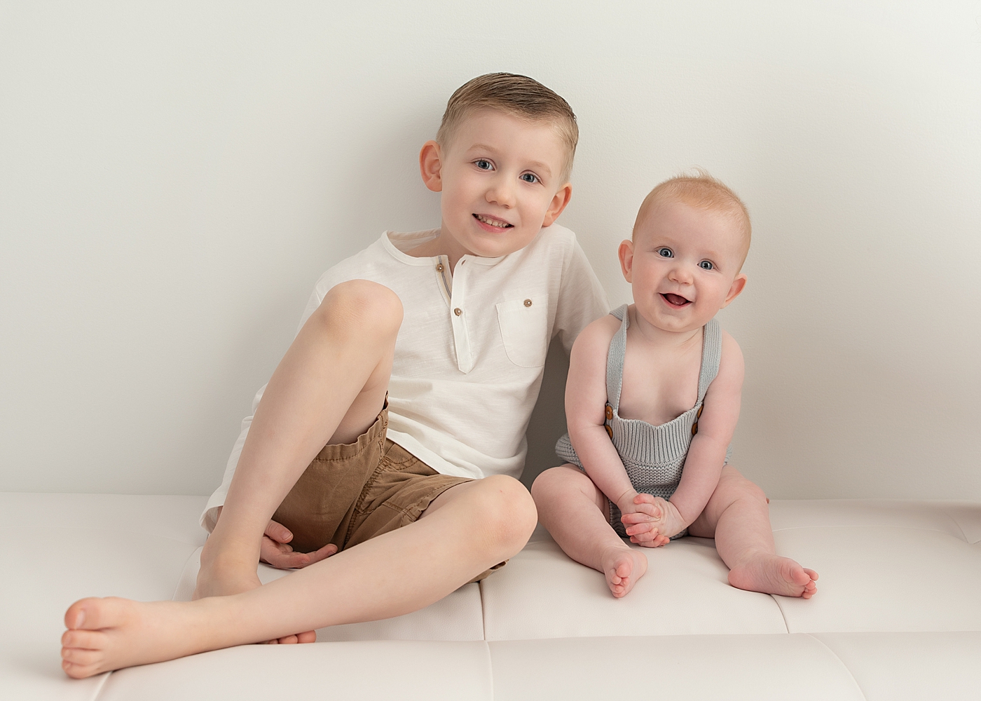 Two brothers sitting together for a picture with Rachel Brookes Photography, a Chagrin Falls baby photographer. 