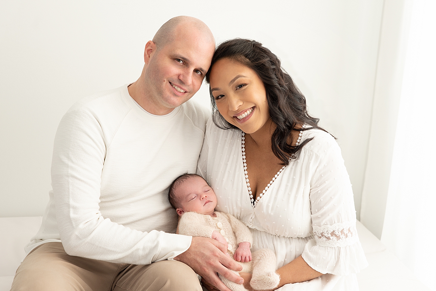 Mom and Dad with their newborn baby boy. Photo by Rachel Brookes Photography.