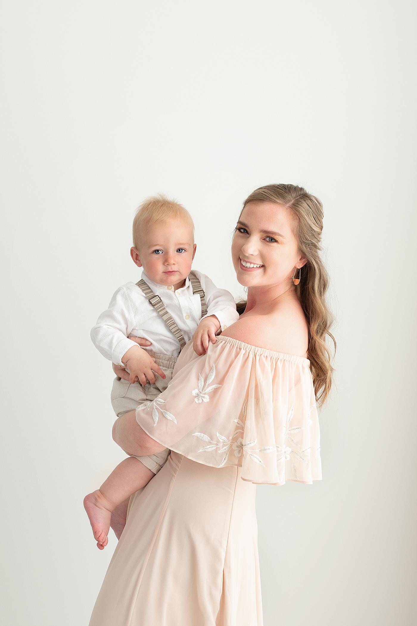 Mom holding her one year old son for photos with Rachel Brookes Photography.