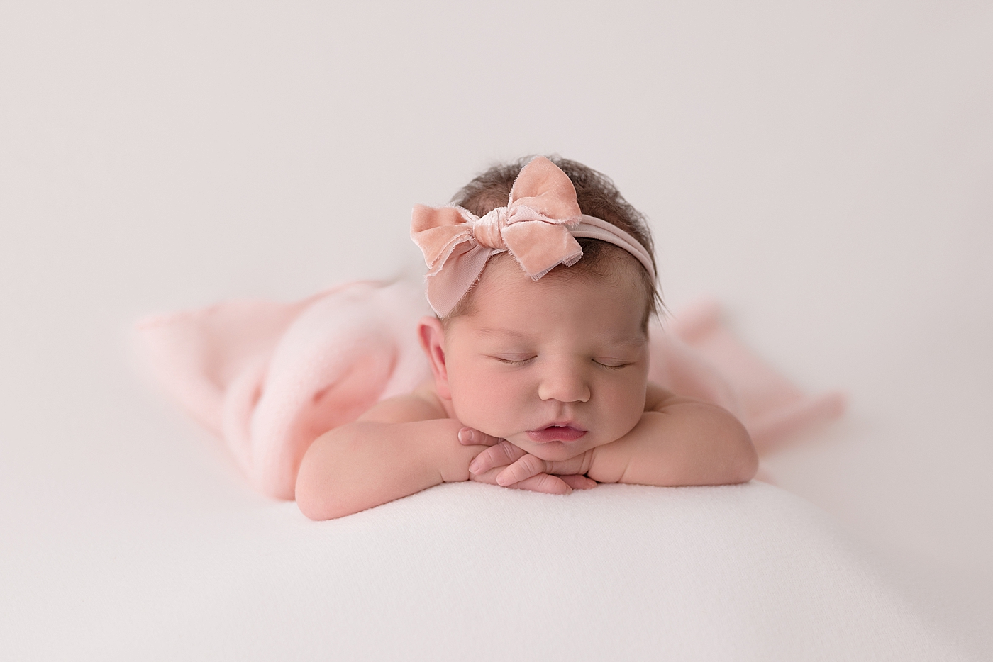 Baby girl posed on her belly for newborn photos with Cleveland Newborn Photographer, Rachel Brookes Photography.