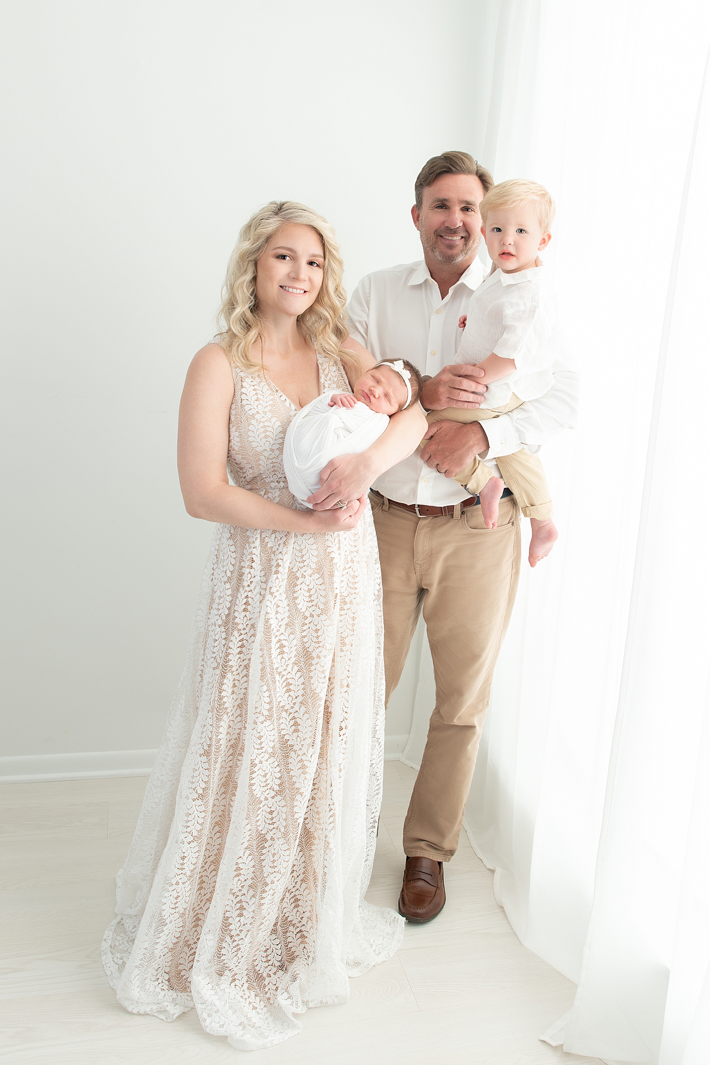 Family of four in Chagrin Falls studio for newborn photos with Rachel Brookes Photography.