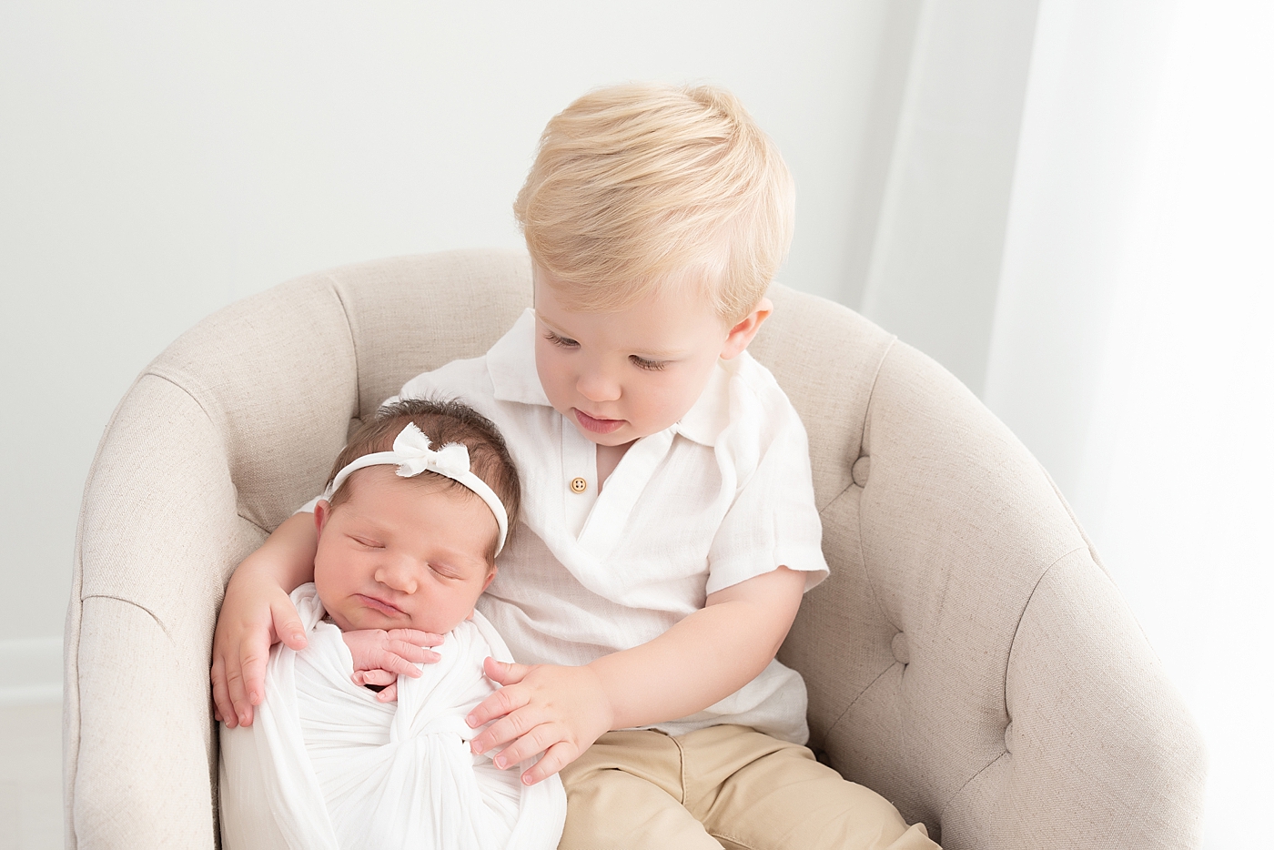 Brother and sister photo in studio during newborn session. Photo by Rachel Brookes Photography.
