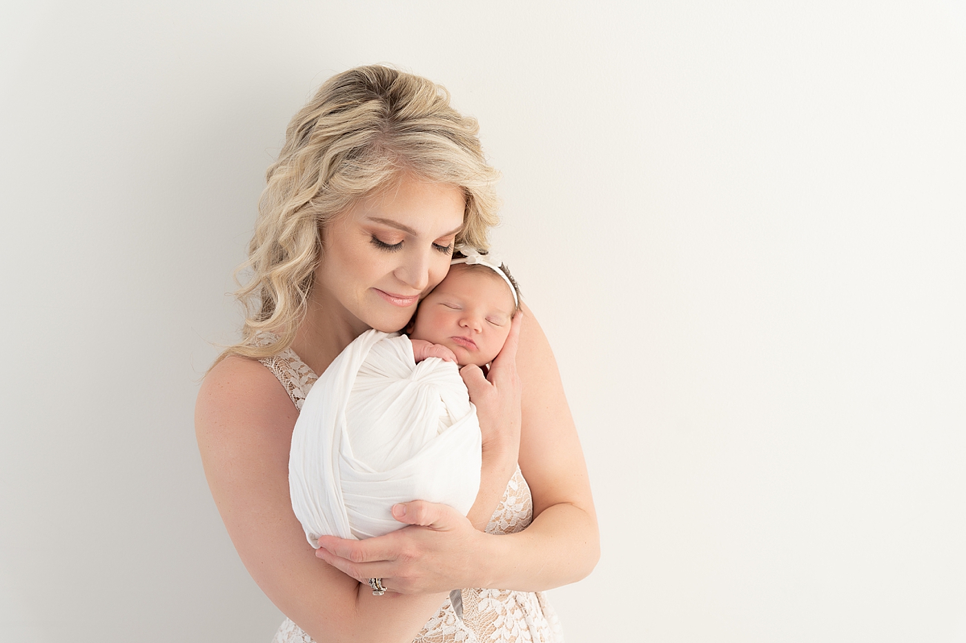 Mom snuggling her baby girl during newborn session. Photo by Rachel Brookes Photography.
